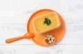 Soup puree in plastic box on plastic orange plate Royalty Free Stock Photo