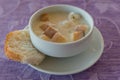 Soup puree in a white bowl with croutons on a napkin and background fabric Royalty Free Stock Photo