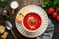 Soup. Tomato cream soup or gazpacho with herbs, seasonings, cherry tomato and parsley in white bowl on dark wooden old background Royalty Free Stock Photo