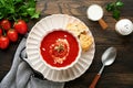 Soup. Tomato cream soup or gazpacho with herbs, seasonings, cherry tomato and parsley in white bowl on dark wooden old background Royalty Free Stock Photo