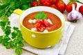 Soup tomato in yellow bowl on granite table Royalty Free Stock Photo