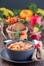 Soup with turkey, pasta, carrot, celery, tomato and cannellini beans on the table with autumn decoration, reflecting the US