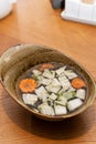 Soup with vegetables and shiitake mushrooms in a bowl, Asian cuisine, vegetarian food. Vertical orientation, hard light Royalty Free Stock Photo