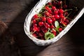 Sour cherries in basket on wood Royalty Free Stock Photo