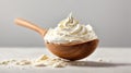 Sour cream in a wooden spoon on a white background Royalty Free Stock Photo