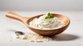 Sour cream in a wooden spoon on a white background. Royalty Free Stock Photo