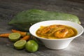 Sour curry shrimp and green papaya on wood.Thai food and traditional Royalty Free Stock Photo