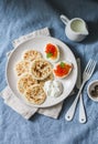 Sour dough pancakes and boiled eggs with red caviar - delicious breakfast, brunch on a blue background Royalty Free Stock Photo