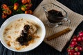 Sour-milk yogurt dessert, with thermostatic cooking, decorated with ripe cherry berries in syrup, on a dark background with jam in Royalty Free Stock Photo