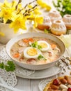 The sour soup ÃÂ ÃÂ»urek, polish Easter soup with the addition of sausage, hard boiled egg and vegetables in a ceramic bowl