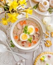 The sour soup ÃÂ¼urek, polish Easter soup with the addition of sausage, hard boiled egg and vegetables in a ceramic bowl