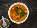 Sour and spicy Tom Yum Goong soup on a table in a restaurant. Thai traditional food. Authentic traditional Thai soup Tom Yam on a Royalty Free Stock Photo