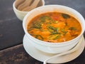 Sour and spicy Tom Yum Goong soup on a table in a restaurant. Thai traditional food. Authentic traditional Thai soup Tom Yam on a Royalty Free Stock Photo