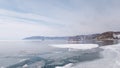 The source of the Angara river from lake Baikal. Spring day, people have fun on a floating ice floe in Siberia. Extreme people