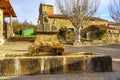 Source of fresh mountain water in the square of the old stone village, Spain. Royalty Free Stock Photo