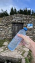 Source of the Morava River, Czech Republic. Hand holding a plastic bottle filled with water from the source Royalty Free Stock Photo