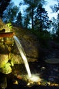 The source of natural water, wellspring, flowing through rocks in forest Royalty Free Stock Photo