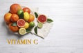 Source of Vitamin C. Different citrus fruits on white wooden table, flat lay Royalty Free Stock Photo