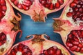 Cut in half pomegranate on a wooden blue surface: sources of vitamins and antioxidants in the winter, food for vegans Royalty Free Stock Photo