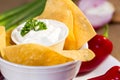 Sourcream with corn chips and red hot chilli peppers. Royalty Free Stock Photo