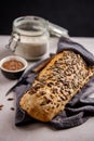 Sourdough artisan bread with pumpkin seeds on a towel.