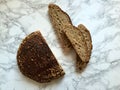 Sourdough artisanal bread loaf and slices on marble countertop