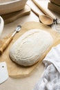 Sourdough bread loaf scoring in banneton, raw dough in proofing rattan basket, homemade bread made from wild yeast