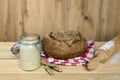 sourdough, bread, rolling pin and wheat ears on wooden background, focus on yeast Royalty Free Stock Photo