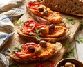 Sourdough bread sandwiches with paprika hummus, olives, slices of red pepper and herbs close up view. Royalty Free Stock Photo