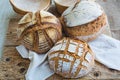 Sourdough breads homemade on a wooden tray with bannetons on background Royalty Free Stock Photo