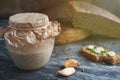 Sourdough in glass jar, cloves garlic, bitten sandwich of artisan bread with onion, and cuts loaf rye bread Royalty Free Stock Photo