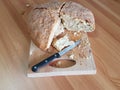 Sourdough handmade bread cut on wooden background with a knife