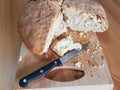 Sourdough handmade bread cut on wooden background with a knife