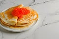 Sourdough pancakes with red salmon caviar traditional for Russian pancake week Royalty Free Stock Photo