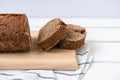 Sourdough rye bread sliced on a cutting board on white wooden table Royalty Free Stock Photo