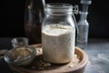 sourdough starter, fermenting in glass jar with airlock