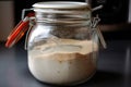 sourdough starter, fermenting in glass jar with airlock