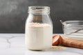 sourdough starter in glass jar, ready for use and feeding