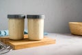 Sourdough starter in glass jars, bright background, copy space Royalty Free Stock Photo