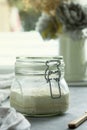 Sourdough starter in a jar, yeast-free leaven starter for healthy organic rustic bread, home baking concept