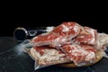 Sous vide immersion circulator cooker and the meats Packeds on a dark background Royalty Free Stock Photo