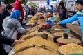 Customers examine merchandise at a stall selling seeds, nuts, grains and other cereals at the local market in Sousse