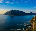 South Africa Hout Bay Cape Town blue hour scenic, idyllic landscape and seascape with a sunset over a blue calm sea with mountains Royalty Free Stock Photo