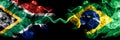 South Africa vs Brazil, Brazilian smoky mystic flags placed side by side. Thick colored silky abstract smoke flags concept