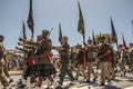 South African Army marches in formation, carrying rifles and flags