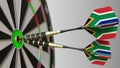 South African national achievement. Flags of the SAR on darts hitting bullseye. Conceptual 3D rendering Royalty Free Stock Photo