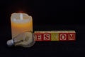 The term Eskom, a broken light bulb and a lit candle