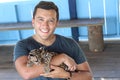 South American man holding an ocelot