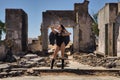 South American woman, young, beautiful, brunette with lingerie and black wings, posing in the middle of some ruined buildings in Royalty Free Stock Photo