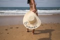 South American woman, young and brunette with bikini and hat with the word summer held in her hand, on her back, running. Concept Royalty Free Stock Photo